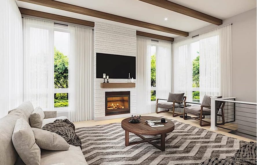 客厅向天花板,一个现代壁炉,缓冲扶手椅,灰色的沙发,咖啡桌坐在雪佛龙面积地毯。