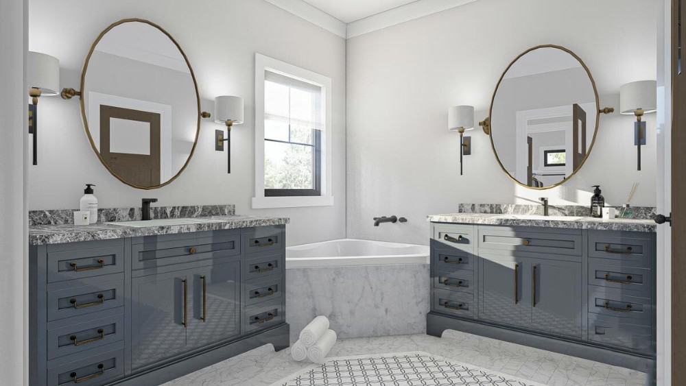 主浴室配备了一个角落的浴缸，以及带有圆形镜子的洗手池梳妆台。