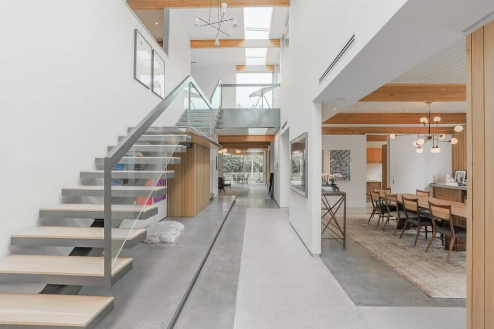 入口走廊有裸露的横梁，一座现代化的楼梯，以及一个带有天窗的两层天花板。图片来自Toptenrealestatedeals.com。