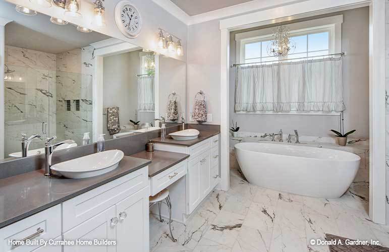 主浴室设有一个独立的浴缸和一个双洗手台，中间有一个化妆台。
