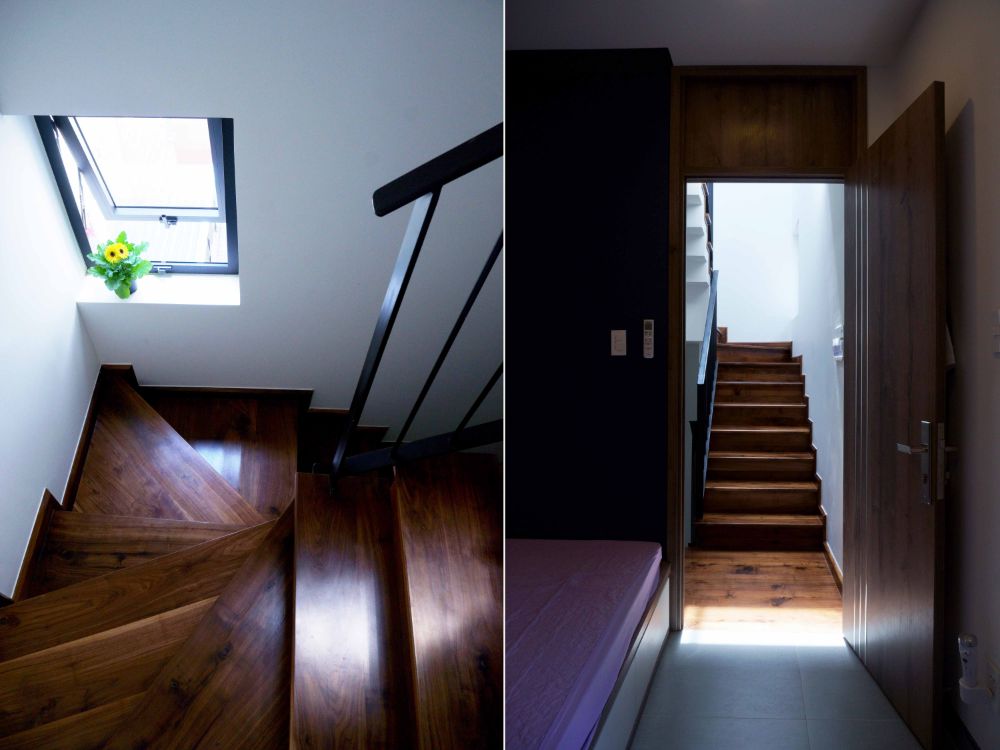 胡桃木螺旋和U型楼梯设计，单窗格窗户，允许自然光进入。