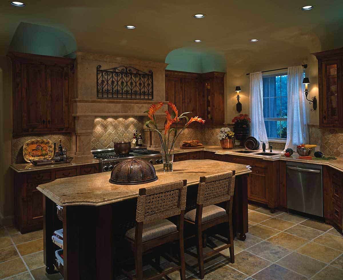 厨房花岗岩台面,双水槽,木制柜,和早餐岛有两个座位。