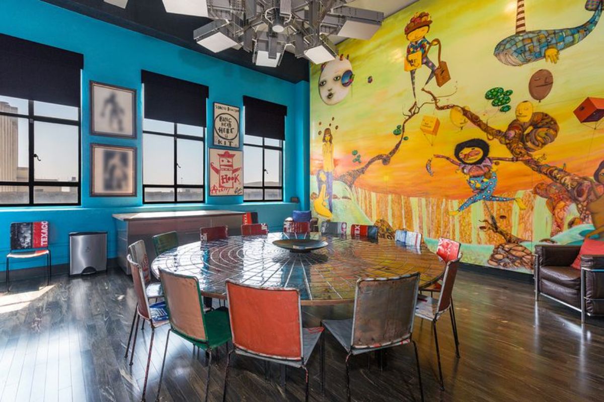餐厅里有一个大圆桌，墙上有一幅彩色的壁画。图片来自Toptenrealestatedeals.com