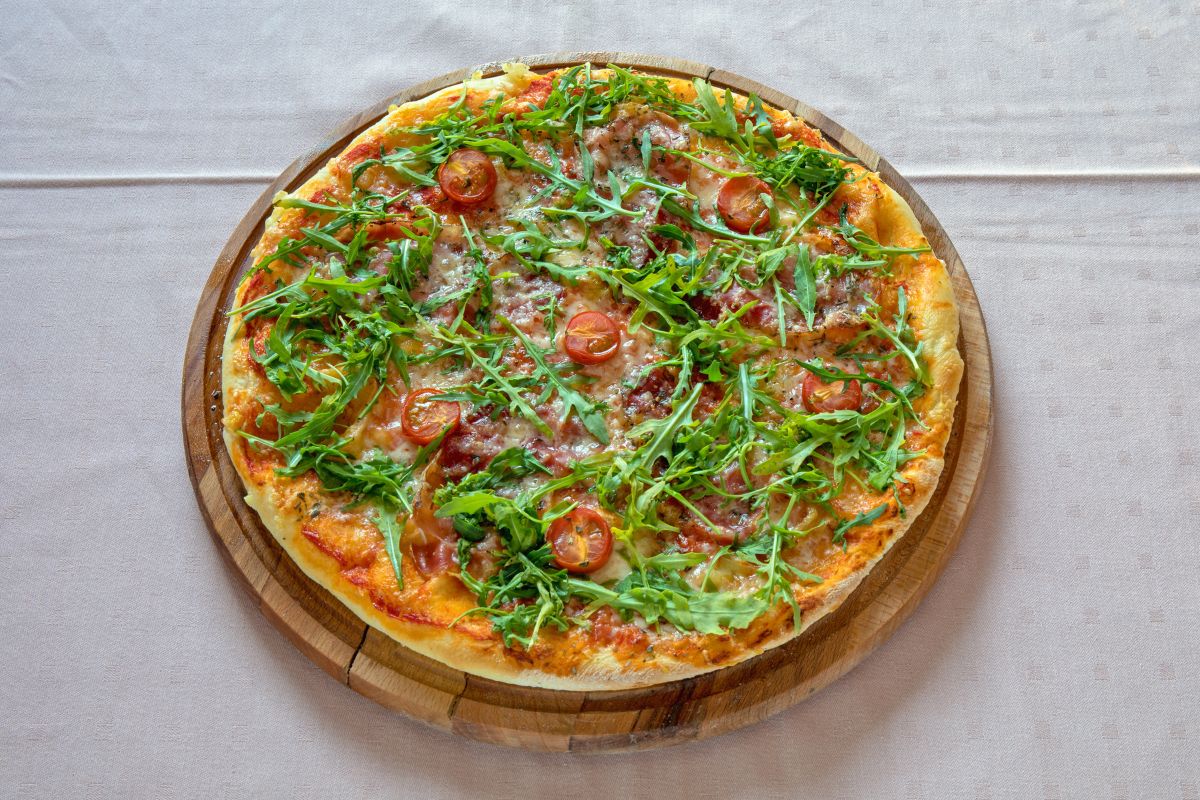 传统的意大利菜配芝麻菜和番茄披萨。