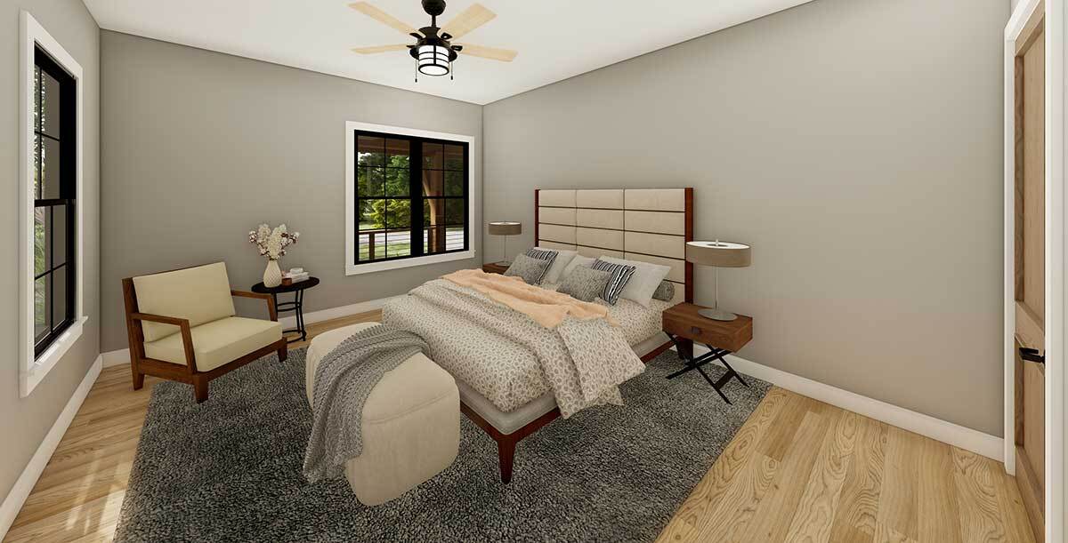 一张米色的软垫床，一张配套的软垫椅子和一个奥斯曼脚凳完成了主卧室。