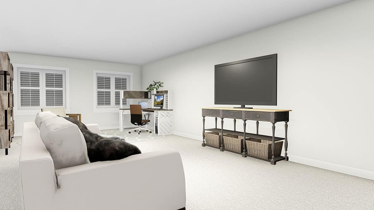 下层的家庭娱乐室，有一张电脑桌、一张灰色沙发和一台大电视。