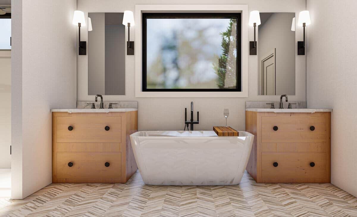 主浴室有一个独立式浴缸放置在图像窗口。在他和她的虚荣。