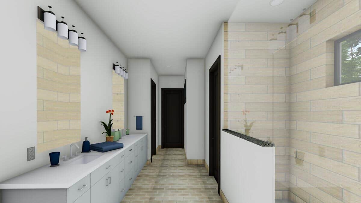 主浴室有一个长长的梳妆台和一个步入式淋浴间，用线形瓷砖突出。