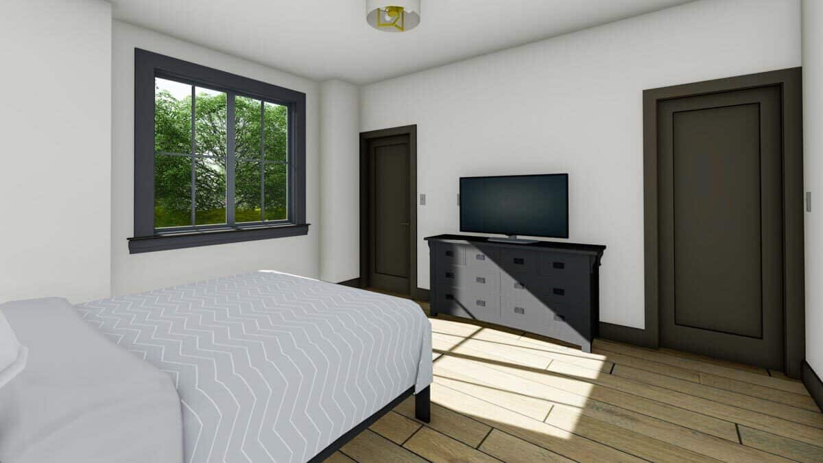 第二间卧室里有一台电视和与木门相配的深色木质家具。