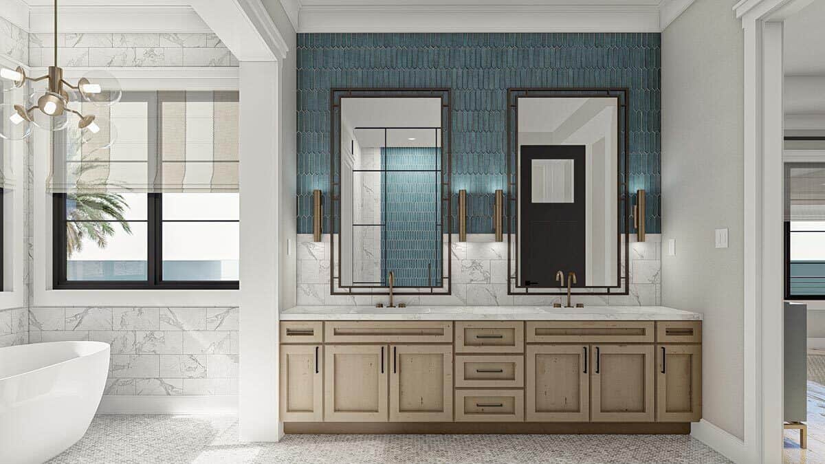 主浴室设有独立浴缸和木制梳妆台，配有双水槽，大理石台面和装饰性镜子。