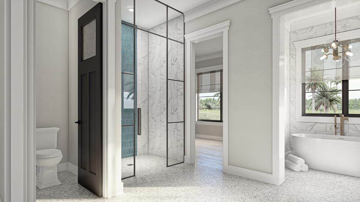 主浴室包括一间盥洗室和一间步入式淋浴间，淋浴间由框架玻璃板围合。