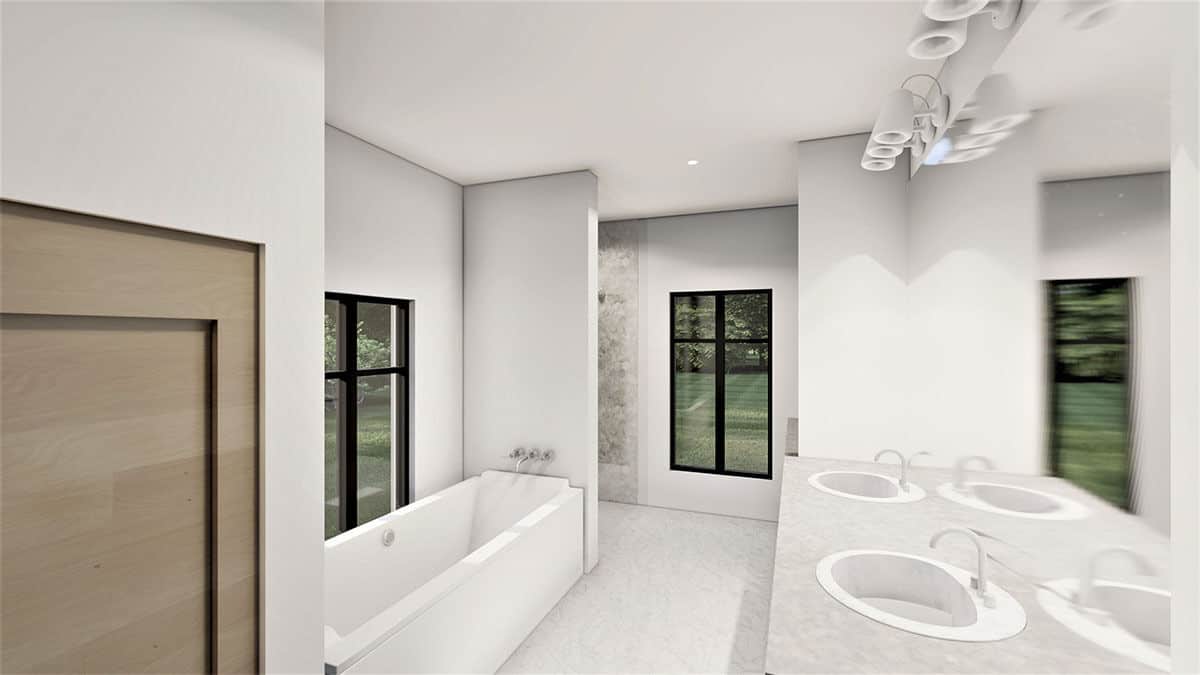 主浴室配有双水槽虚荣,浏览淋浴,深浸浴缸身披着一个框架窗口。
