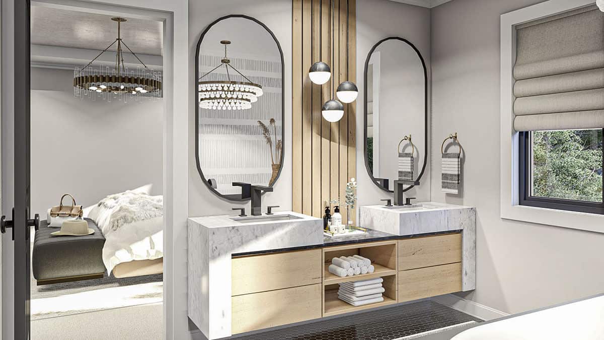 主浴室配有双水槽梳妆台，装饰有椭圆形镜子，玻璃球吊坠和木条口音。