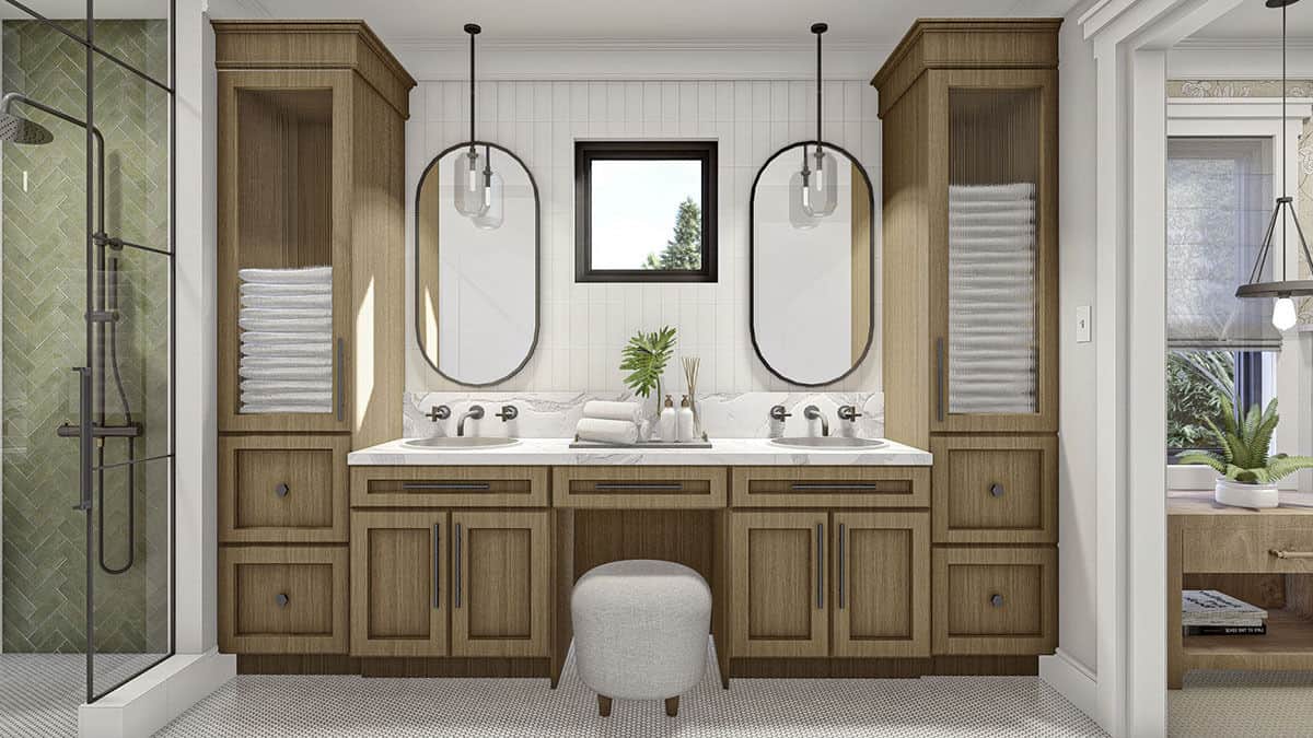 主浴室设有一个配有两个水槽、椭圆形镜子和灰色凳子的大木制梳妆台。
