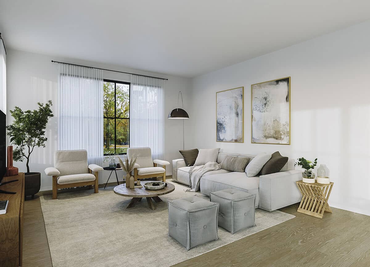 客厅里有现代家具，铺着硬木地板，白色的墙壁上装饰着镶框的艺术品。