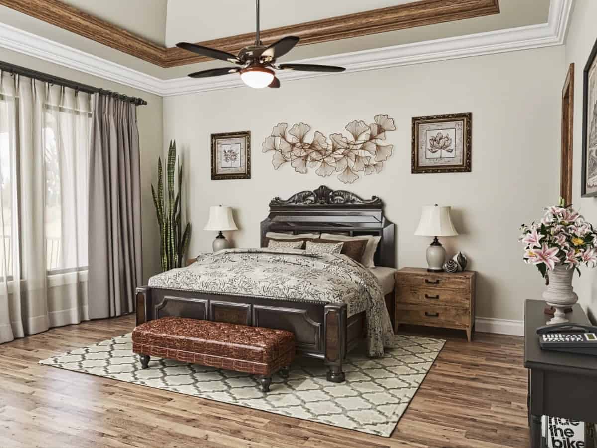 主卧室有托盘天花板和天然硬木地板，上面铺着有图案的地毯。