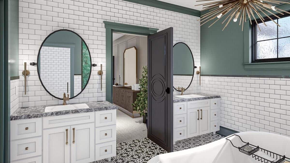 主浴室提供单独的他和她的水槽虚荣搭配圆形的镜子。